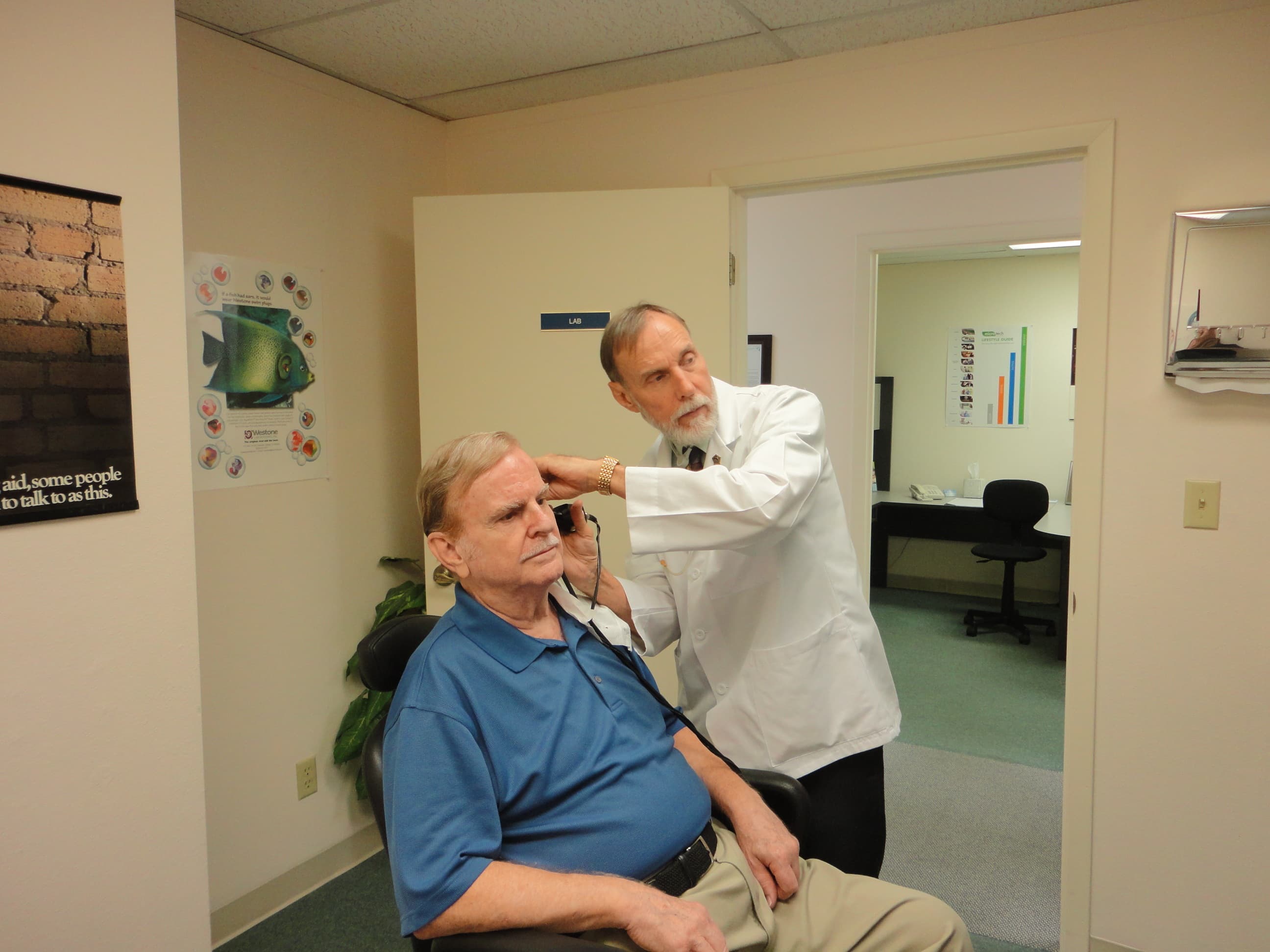 Audiologist performing a hearing check-up for a patient